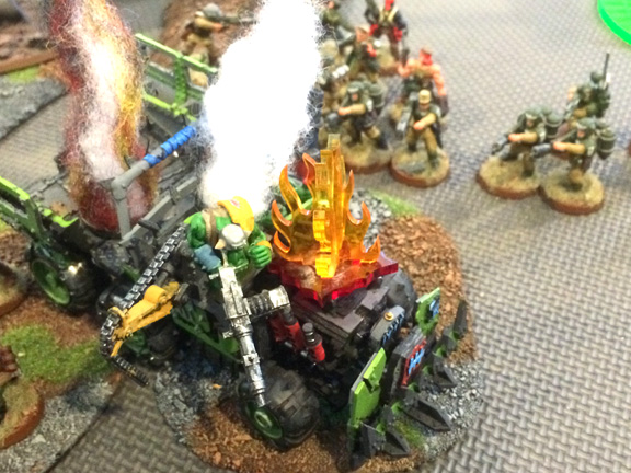 Three flamers and a plasma gun engulf this ork Trukk, incinerating the driver and gunner in holy promethium.